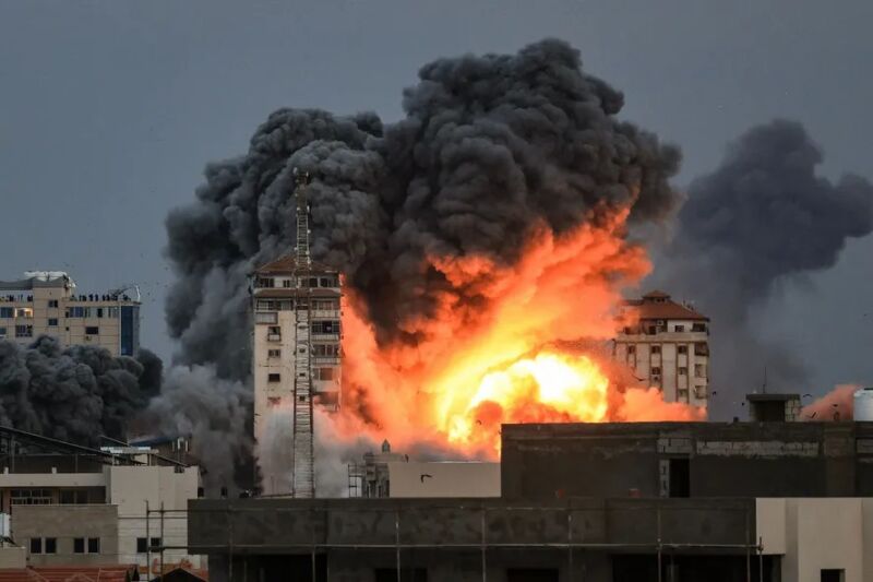 104589081-editors-note-graphic-content-people-standing-on-a-rooftop-watch-as-a-ball-of-fire-and-sm